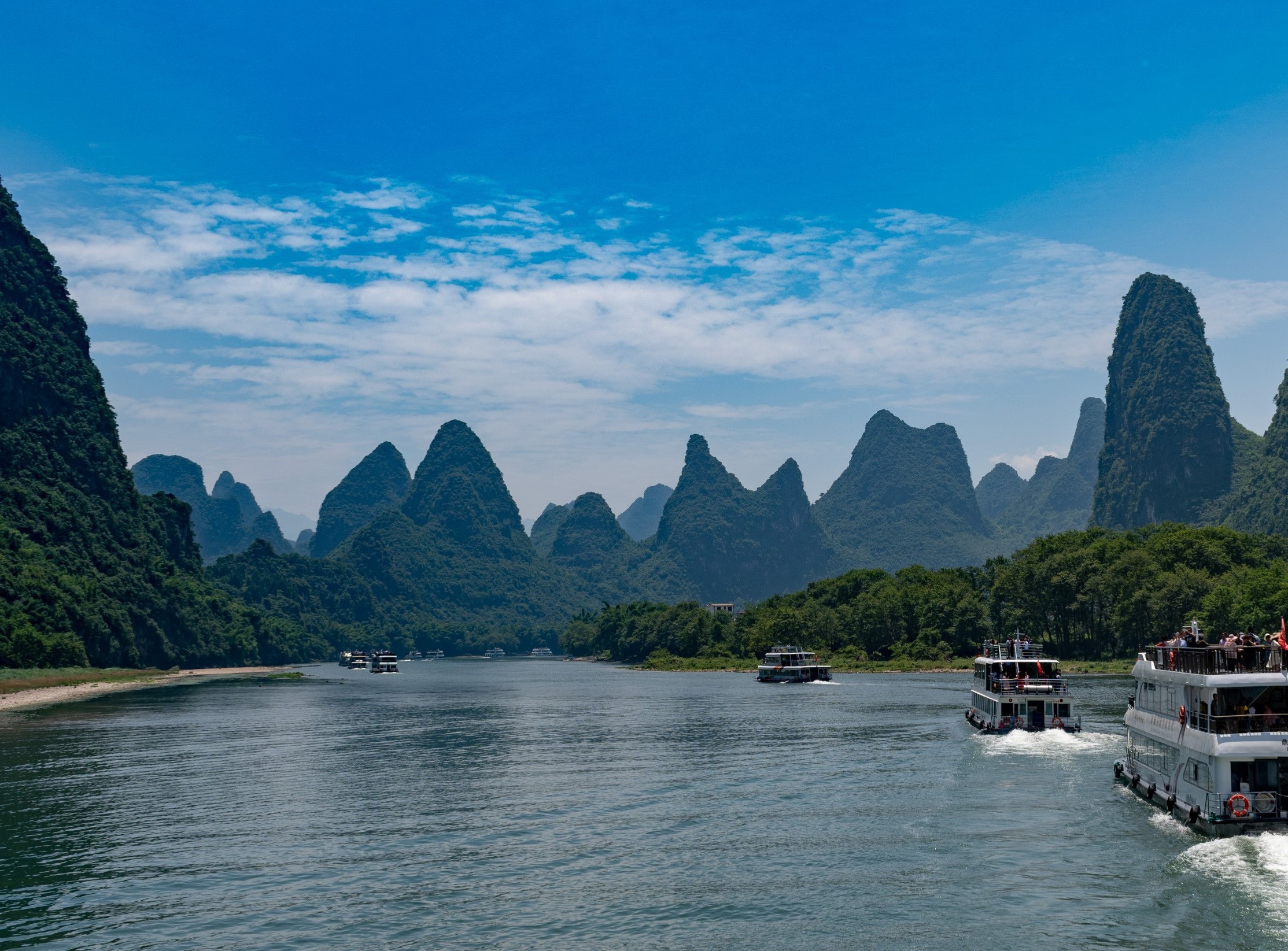 Cruise boats on the Li River among Guilin karst mountains